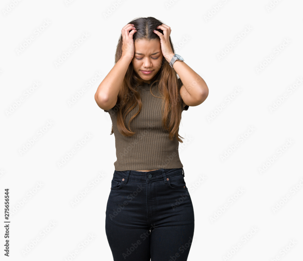 Young beautiful brunette woman over isolated background suffering from headache desperate and stressed because pain and migraine. Hands on head. Young beautiful brunette woman over isolated background suffering from headache desperate and stressed because pain and migraine. Hands on head.
