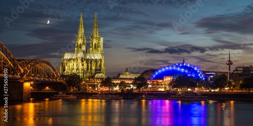 City-panorama of Cologne at dusk, Rhine, Hohenzollern Bridge, cathedral, the Musical Dome, Colonius TV tower, rising moon behind, Cologne, North Rhine-Westphalia, Germany, Europe photo