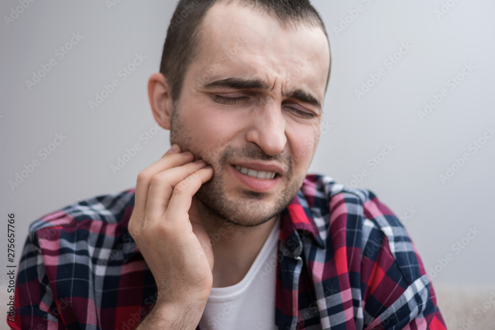Male has a toothache, toothache, grimace from pain, portrait, close up Male has a toothache, toothache, grimace from pain, portrait, close up