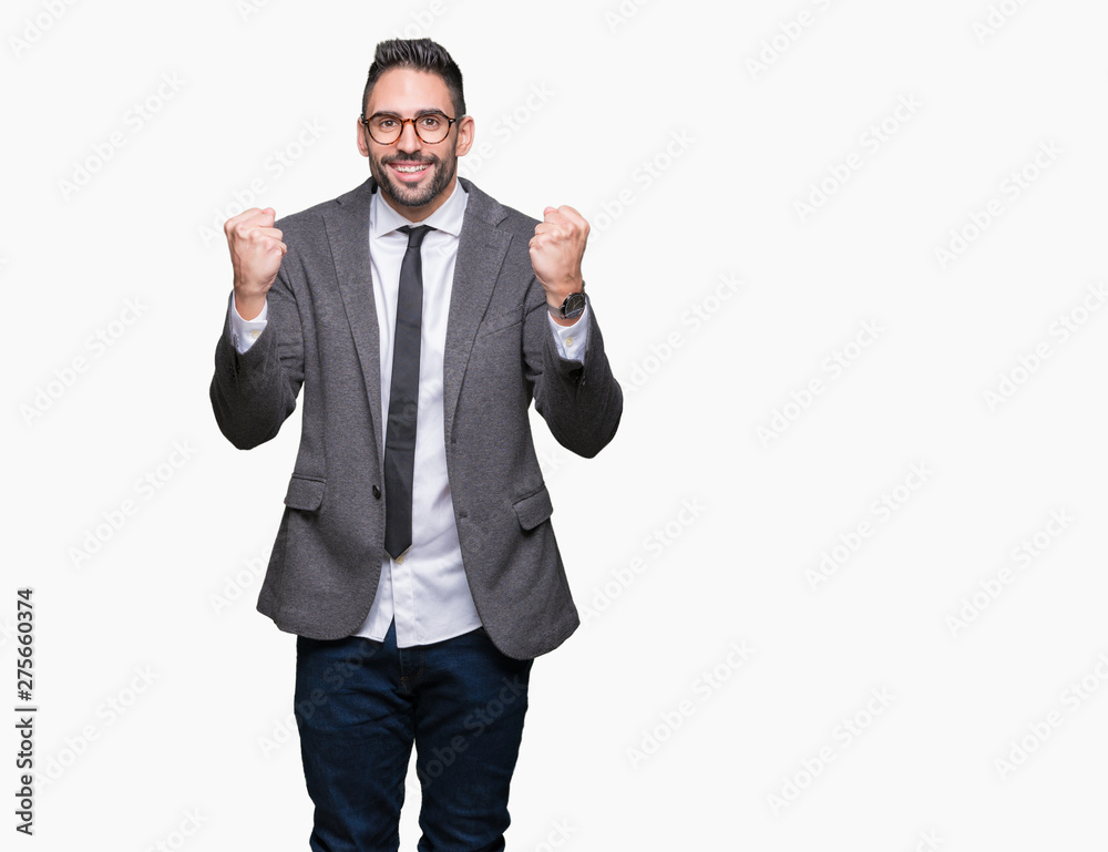 Young handsome business man over isolated background celebrating surprised and amazed for success with arms raised and open eyes. Winner concept.
