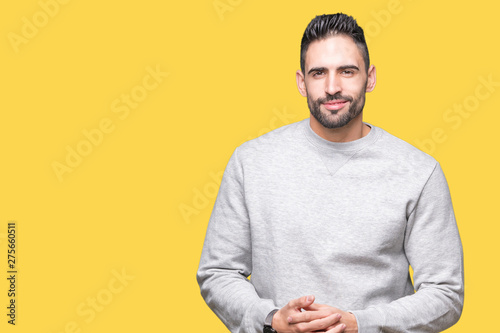 Young handsome man wearing sweatshirt over isolated background Hands together and fingers crossed smiling relaxed and cheerful. Success and optimistic © Krakenimages.com