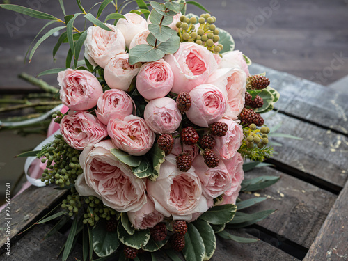 Beautiful wedding bouquet of shrub and peony gently pink roses.