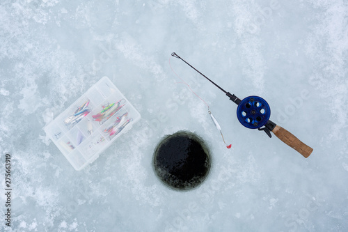 Winter fishing concept. Fishing equipment for ice fishing on the ice. 