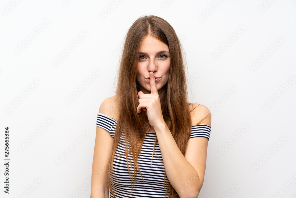 Young woman with long hair over isolated white wall showing a sign of silence gesture putting finger in mouth Young woman with long hair over isolated white wall showing a sign of silence gesture putting finger in mouth