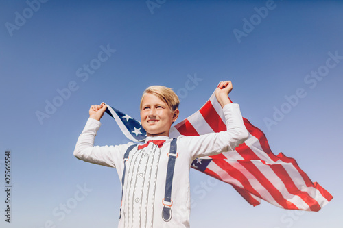 Boy holding American flag. Patriots of America.