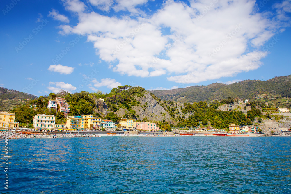 Liguria, Italy coastline of Riviera with colorful houses on sunny warm day. Monterosso al Mare, Vernazza, Corniglia, Manarola and Riomaggiore, Cinque Terre National Park UNESCO World Heritage