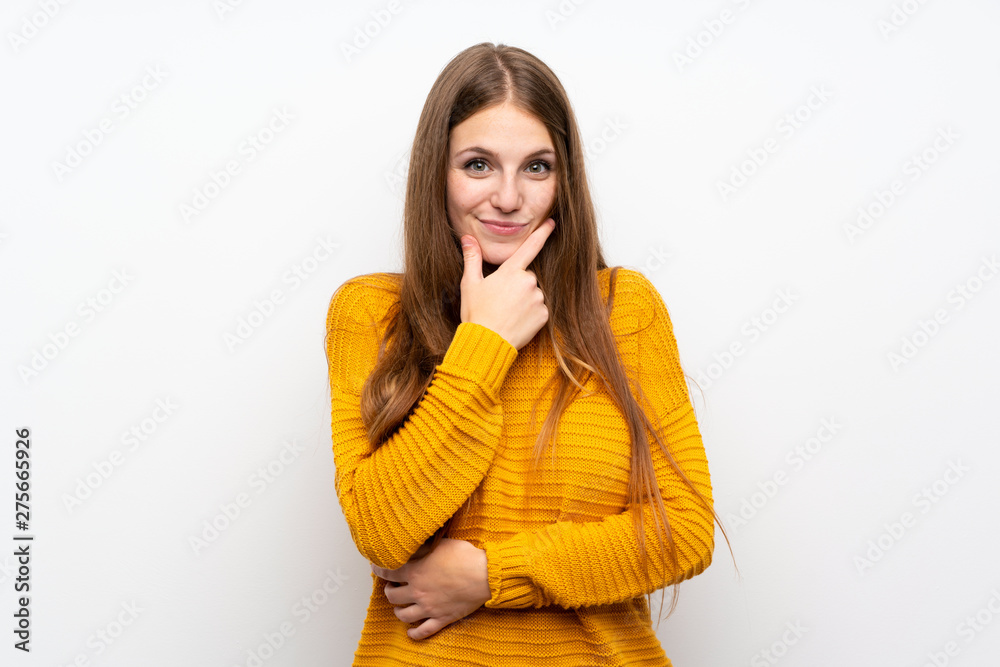 Young woman with yellow over isolated white wall laughing