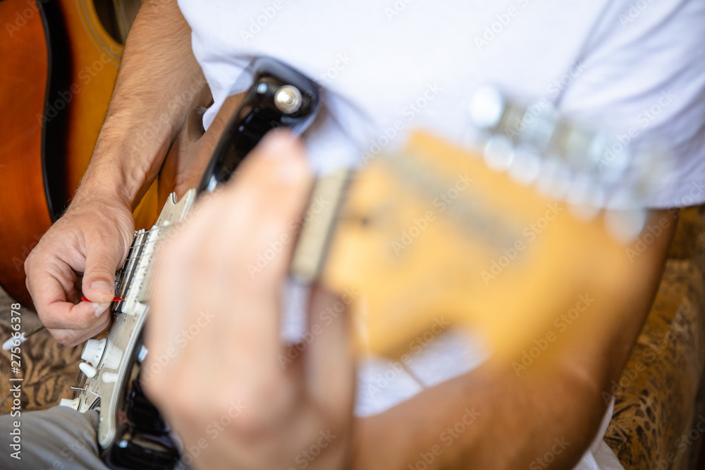 close-up of a guitarist playing an electric guitar