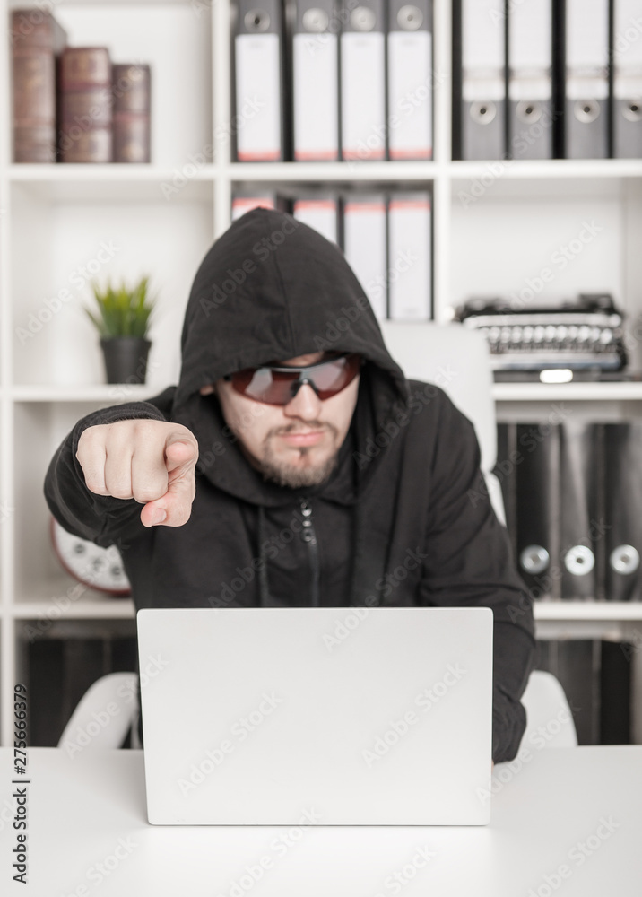 Man hacker showing by finger on you in office. Focus on hand Man hacker showing by finger on you in office. Focus on hand