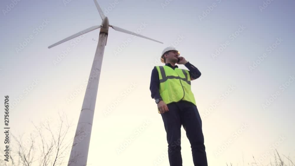custom made wallpaper toronto digitalEngineer of the Caucasian appearance in a helmet and a yellow vest standing near the windmill and talking on a cell phone