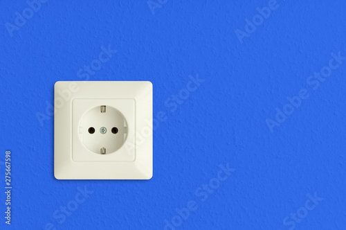 electrical power socket on blue wall, european standard