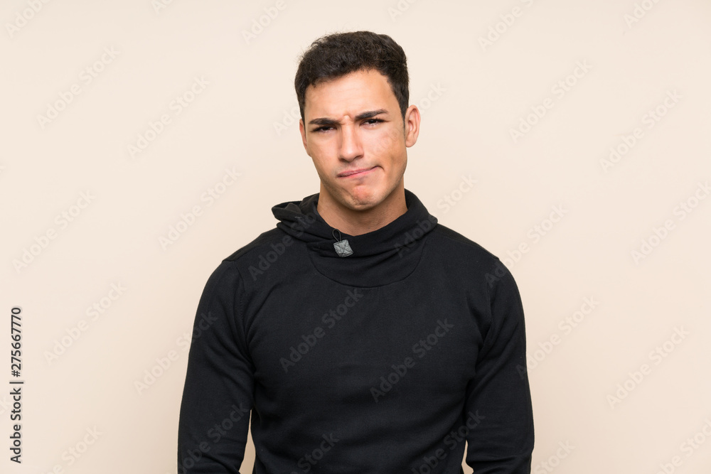 Handsome man over isolated background having doubts and with confuse face expression Handsome man over isolated background having doubts and with confuse face expression