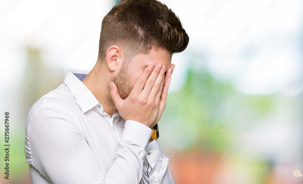 Young handsome business man with sad expression covering face with hands while crying. Depression concept. Young handsome business man with sad expression covering face with hands while crying. Depression concept.