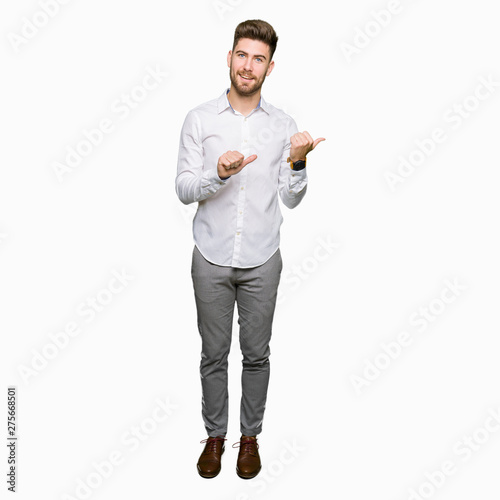 Young handsome business man Pointing to the back behind with hand and thumbs up, smiling confident