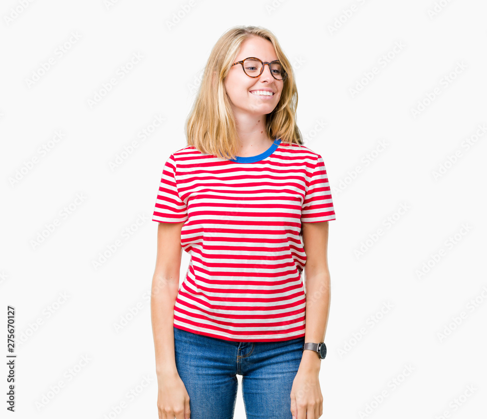Beautiful young woman wearing glasses over isolated background looking away to side with smile on face, natural expression. Laughing confident. Beautiful young woman wearing glasses over isolated background looking away to side with smile on face, natural expression. Laughing confident.