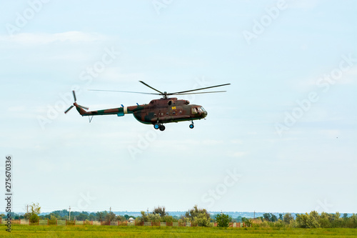 Military Russian helicopter over the field