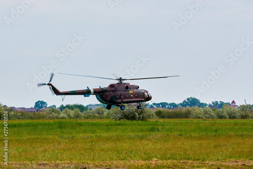 Military Russian helicopter over the field