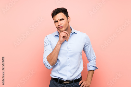 Handsome man over pink background Looking front