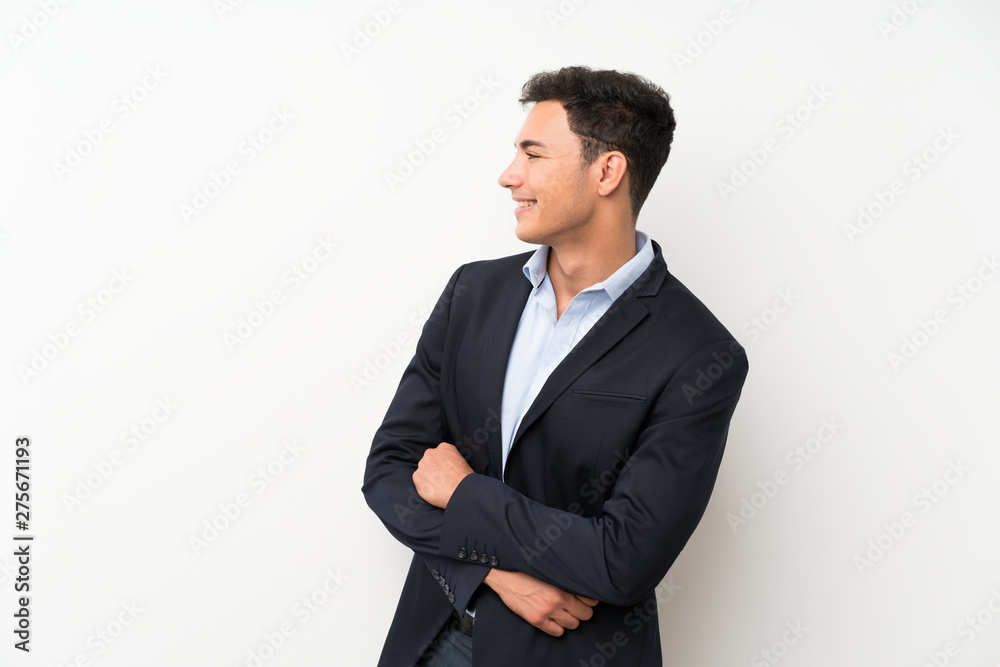 Handsome man over isolated white wall looking to the side Handsome man over isolated white wall looking to the side