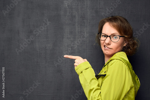 Portrait of discontented girl pointing at something unpleasant