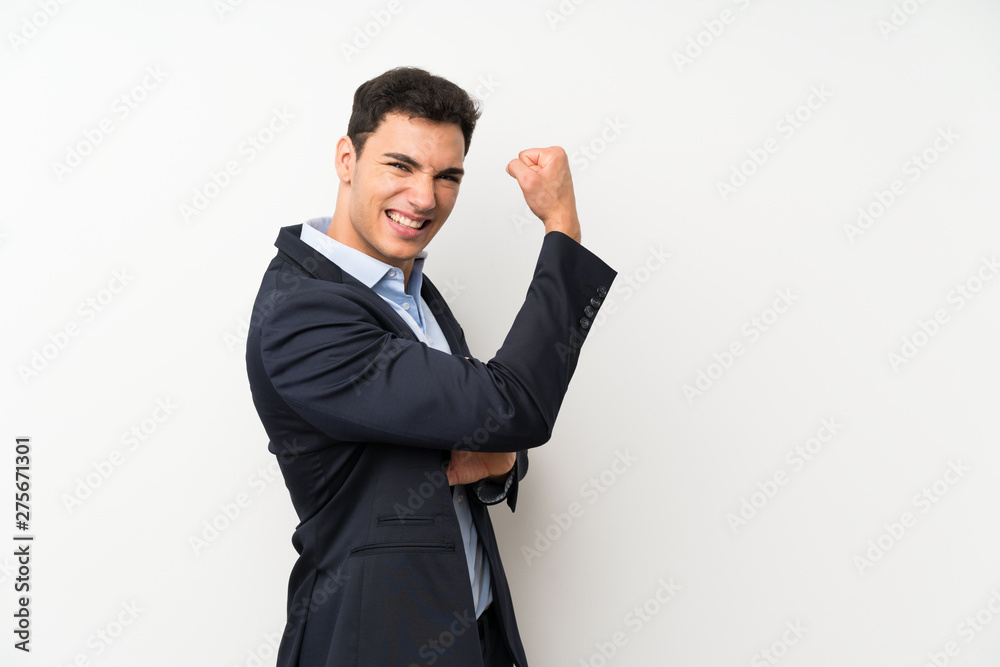 Handsome man over isolated white wall making strong gesture Handsome man over isolated white wall making strong gesture
