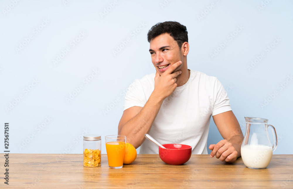 Handsome man in having breakfast thinking an idea Handsome man in having breakfast thinking an idea