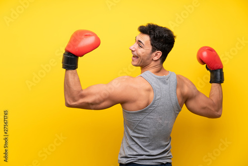 Handsome sport man over isolated background with boxing gloves © luismolinero