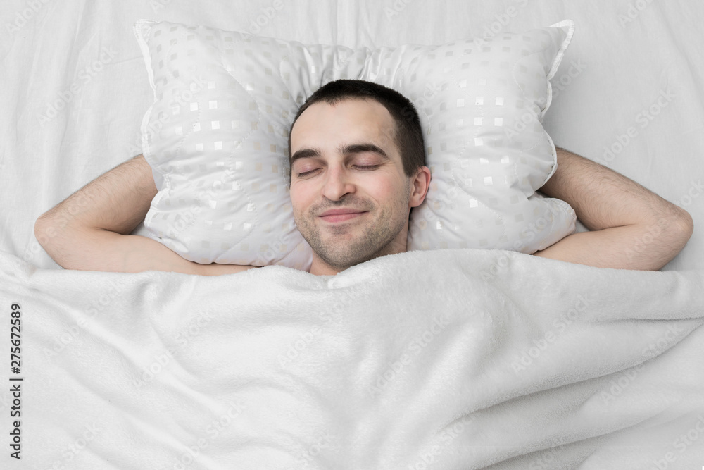 Funny man sleeping in the bedroom, top view Funny man sleeping in the bedroom, top view