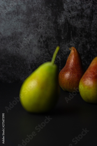 Forelle pears on dark background. Selective focus.