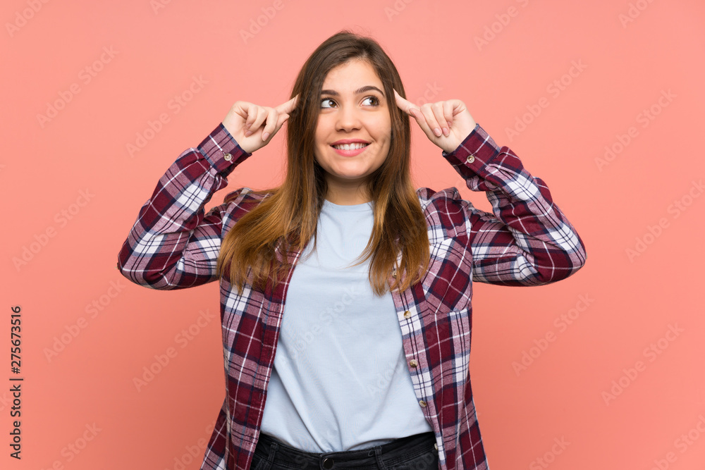 Young girl over pink wall having doubts and thinking Young girl over pink wall having doubts and thinking