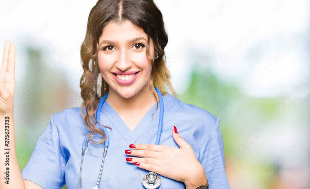 Young adult doctor woman wearing medical uniform Swearing with hand on chest and fingers, making a loyalty promise oath