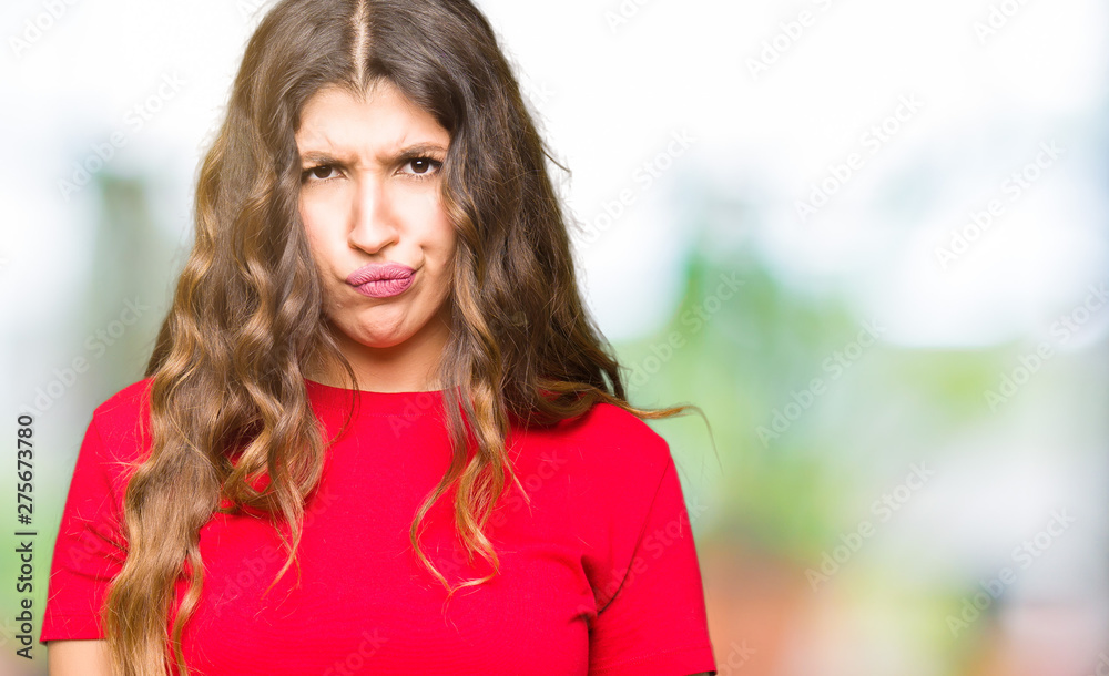 Obraz premium Young beautiful woman wearing casual t-shirt skeptic and nervous, frowning upset because of problem. Negative person.