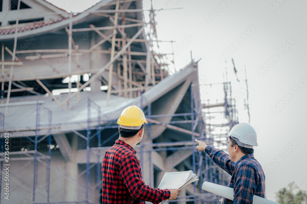 Engineers, construction sites, two businessmen Engineering objects in the workplace with architectural plans Draft construction project