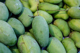Green mangoes in the market.