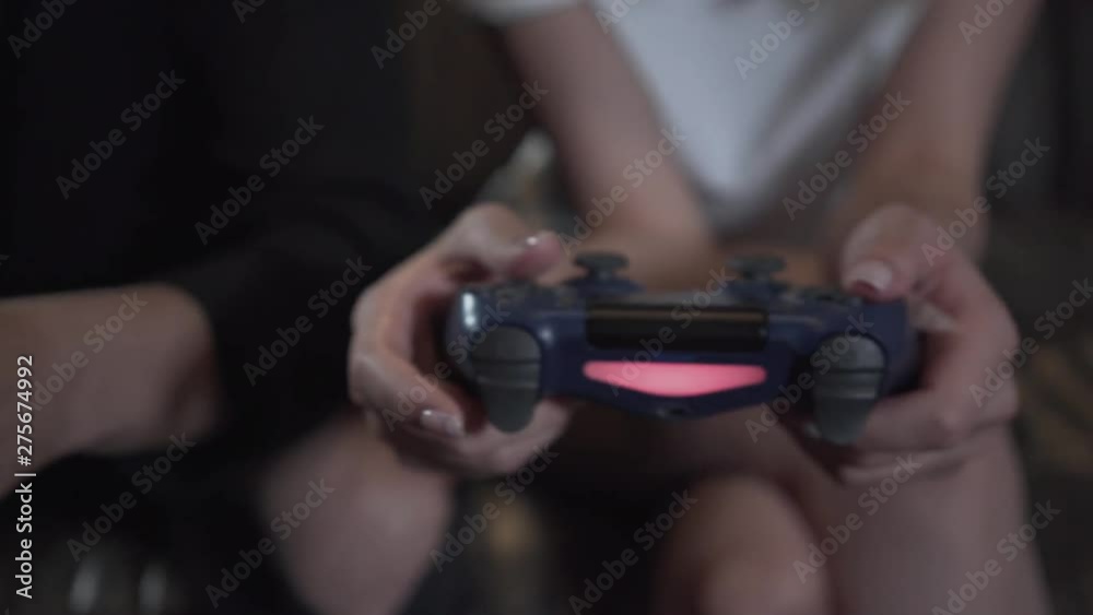 Man and woman playing video game with a joystick close-up. Video game and leisure concept. Man and woman playing video game with a joystick close-up. Video game and leisure concept.