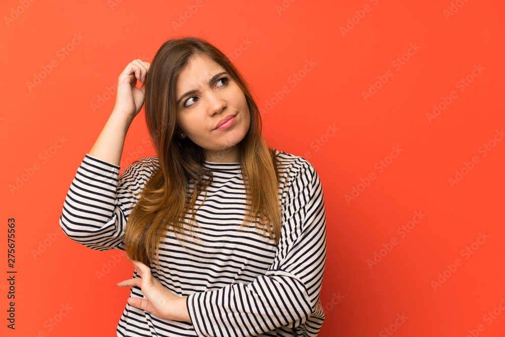 Young girl with striped shirt having doubts and with confuse face expression Young girl with striped shirt having doubts and with confuse face expression