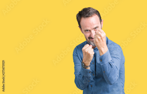 Handsome middle age elegant senior man over isolated background Ready to fight with fist defense gesture, angry and upset face, afraid of problem