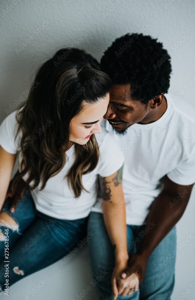 Happy Biracial Couple in Modern White Room Happy Biracial Couple in Modern White Room