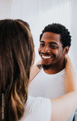 Happy Biracial Couple in Modern White Room