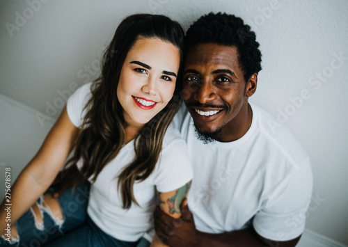 Happy Biracial Couple in Modern White Room