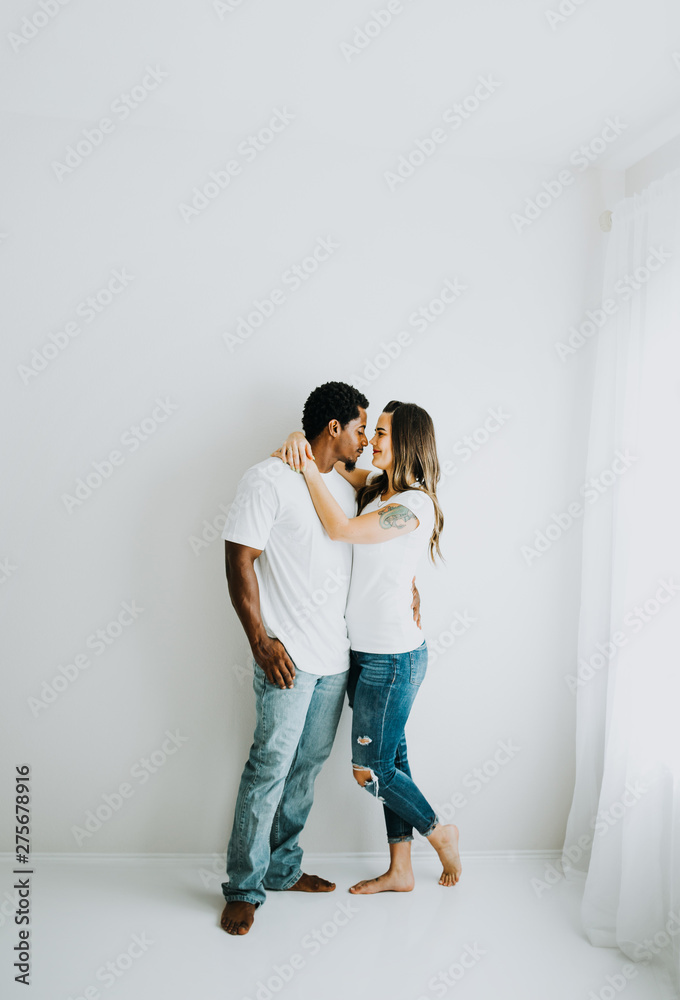 Happy Biracial Couple in Modern White Room Happy Biracial Couple in Modern White Room