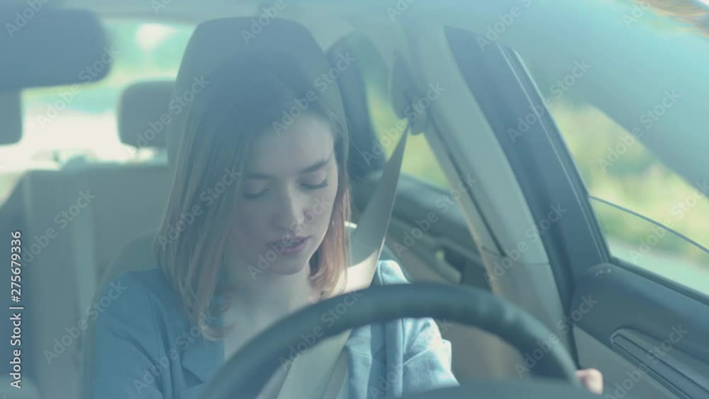 Portrait serious young woman driver talking by phone while driving a car serious sunset sunlight adult cellphone female automobile dangerous connection road sitting smartphone texting slow motion
