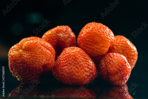 Strawberries on a dark background close-up.