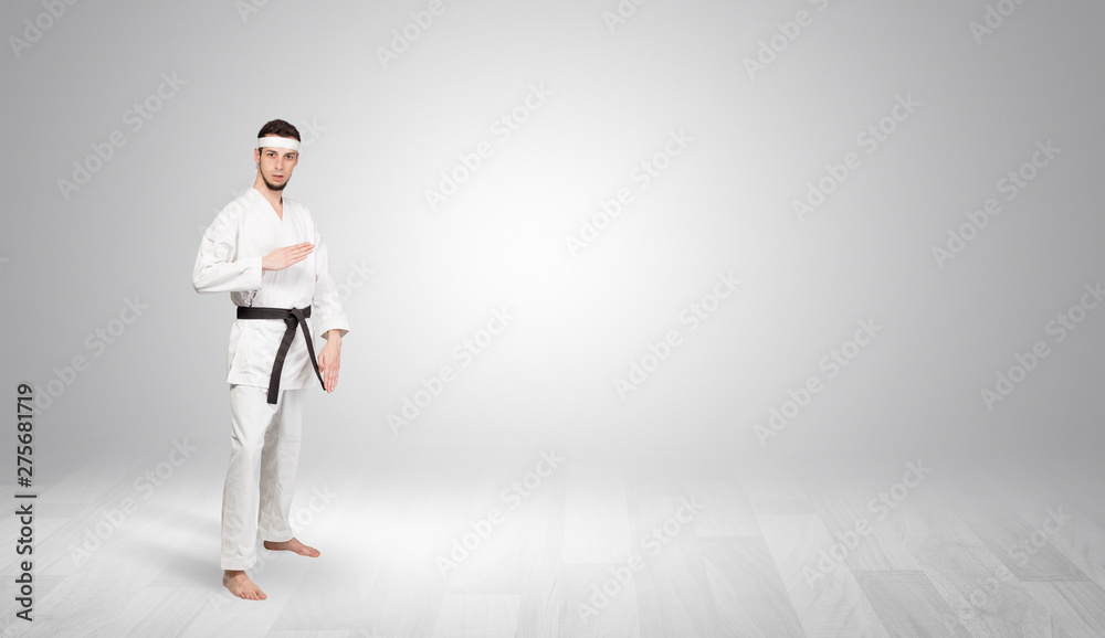 Young kung-fu trainer fighting in an empty space
Young kung-fu trainer fighting in an empty space