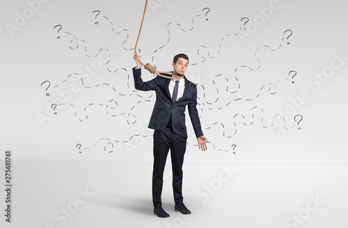 Hopeless young businessman trying to suicide with question signs concept
 photo