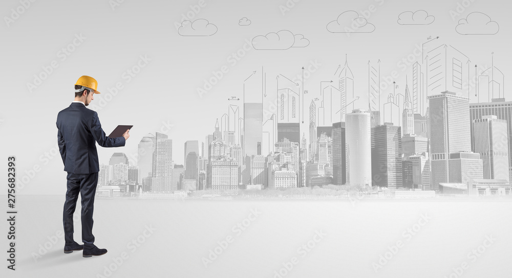 Young supervisor architect standing and replanning a big city panorama
Young supervisor architect standing and replanning a big city panorama