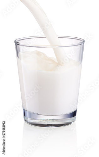 Pouring milk into glass isolated on white background
