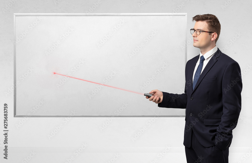 Young businessman with laser pointer and copyspace white blackboard
Young businessman with laser pointer and copyspace white blackboard