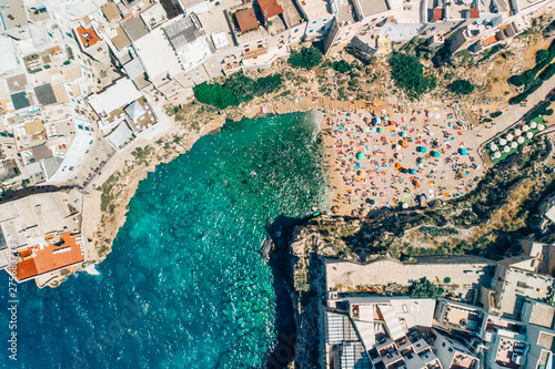 Many tourists relax on beach in Poliano a Mare summer days, drone shot