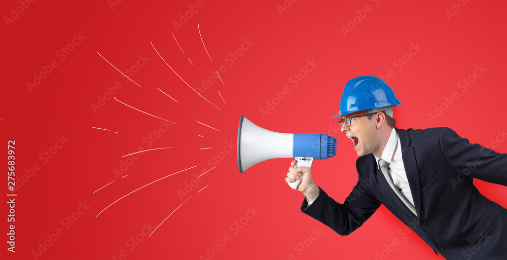 Fototapeta premium Young architect constructor yelling with megaphone and copyspace 